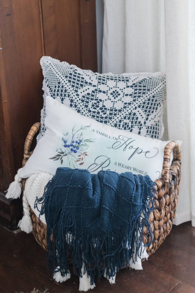 Basket, of Christmas pillows, and blankets in the living room 