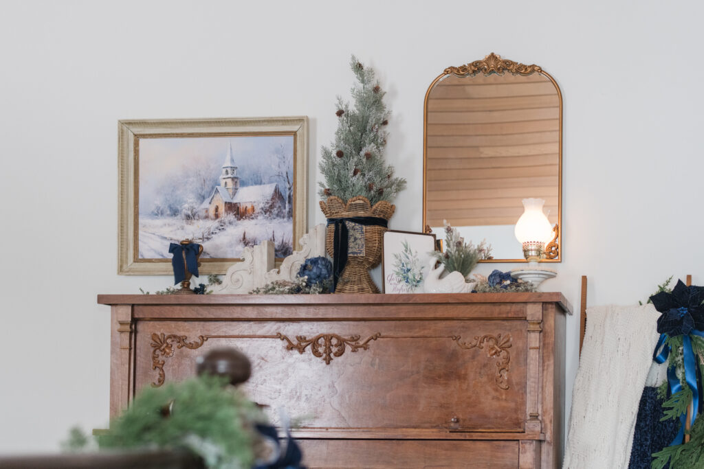 Artwork and a Gilded frame with year-round pieces and Christmas decor on a piano