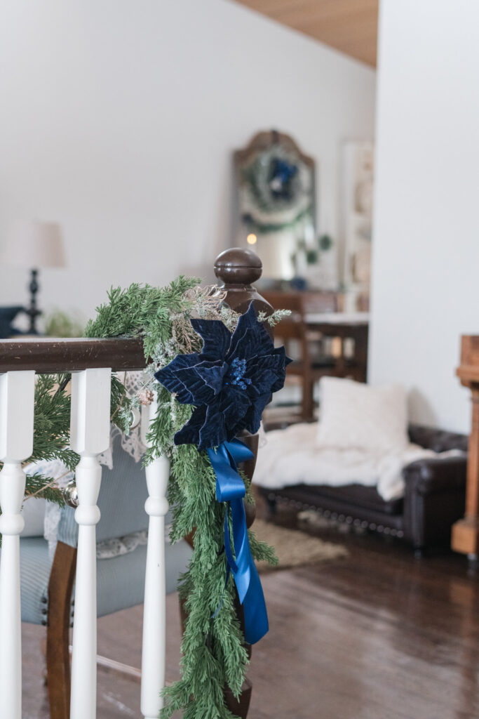 Focussed on the garland hanging on the rail at the front entrance, you can see the rest of the Christmas decor in the dining room beyond
