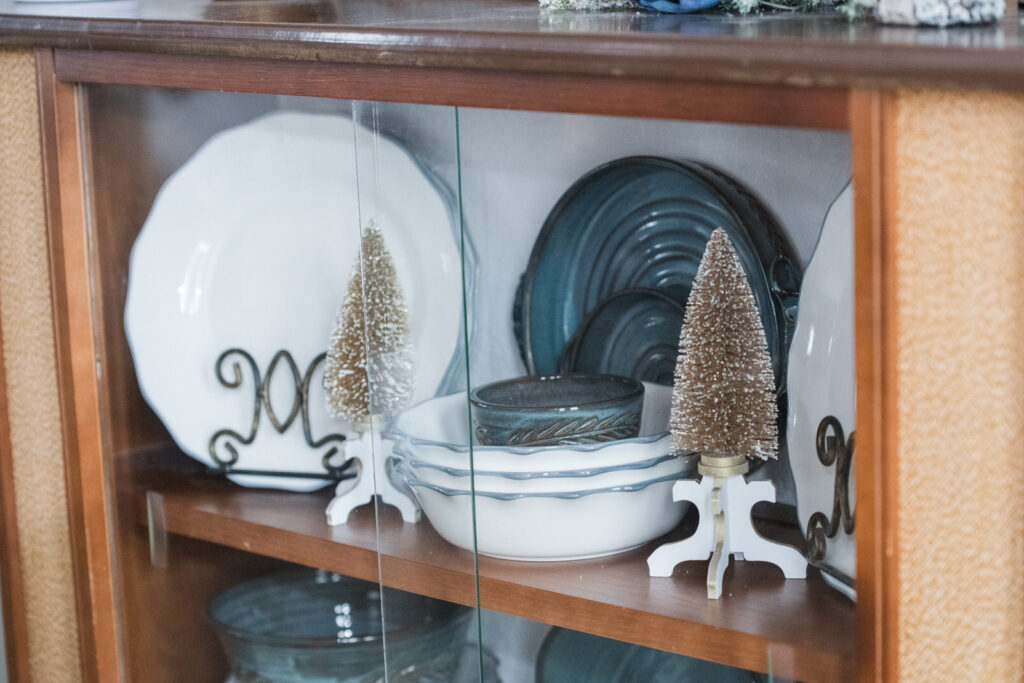  China cabinet with white and blue dishes styled for Christmas