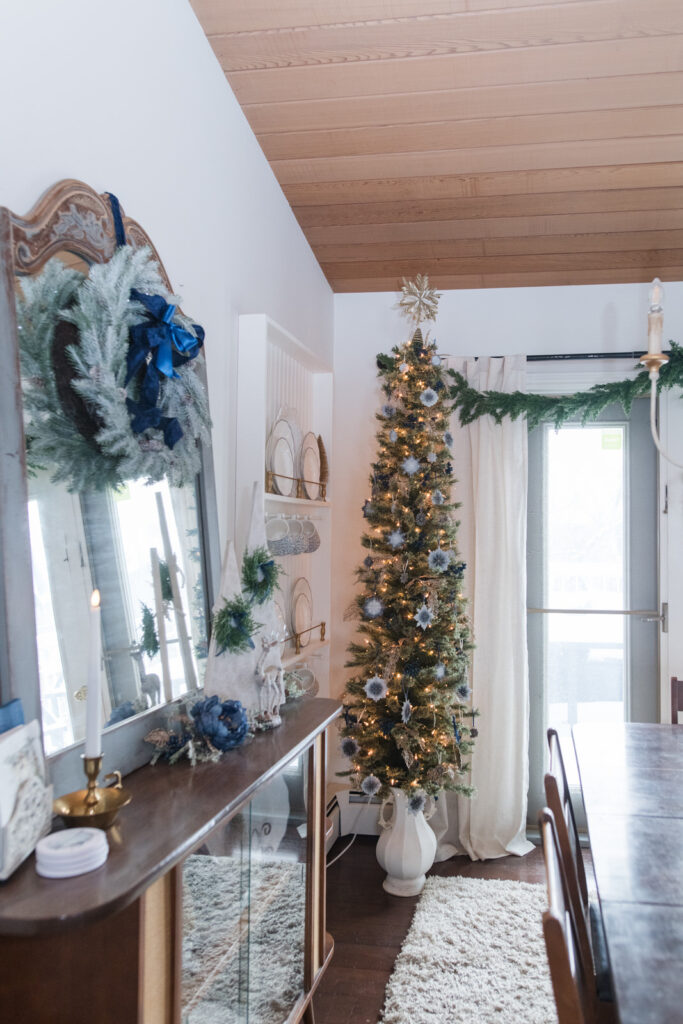  dining room decorated for Christmas with a DIY Christmas tree stand made out of an urn 