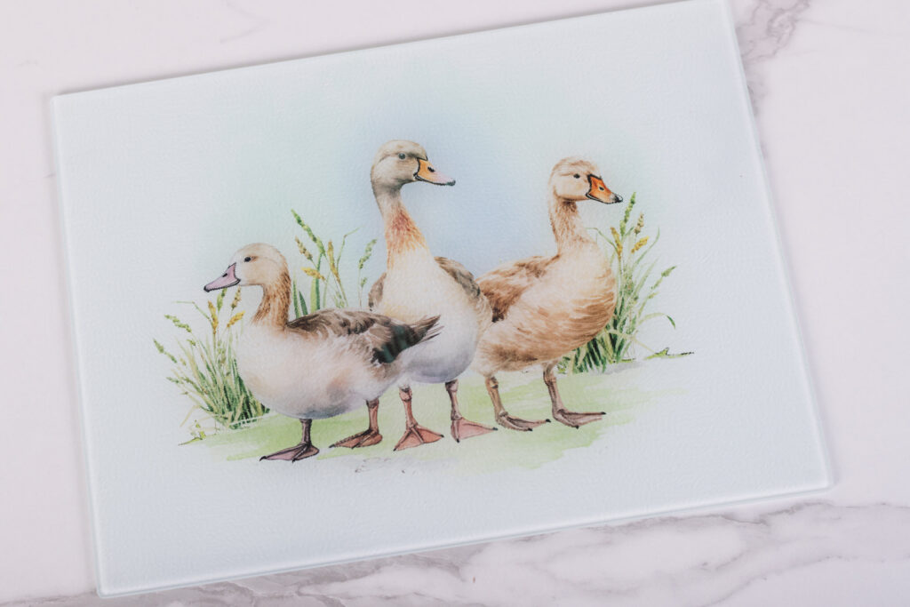 Farmhouse cutting board from the Homestead Collection used for prep and serving featuring ducks