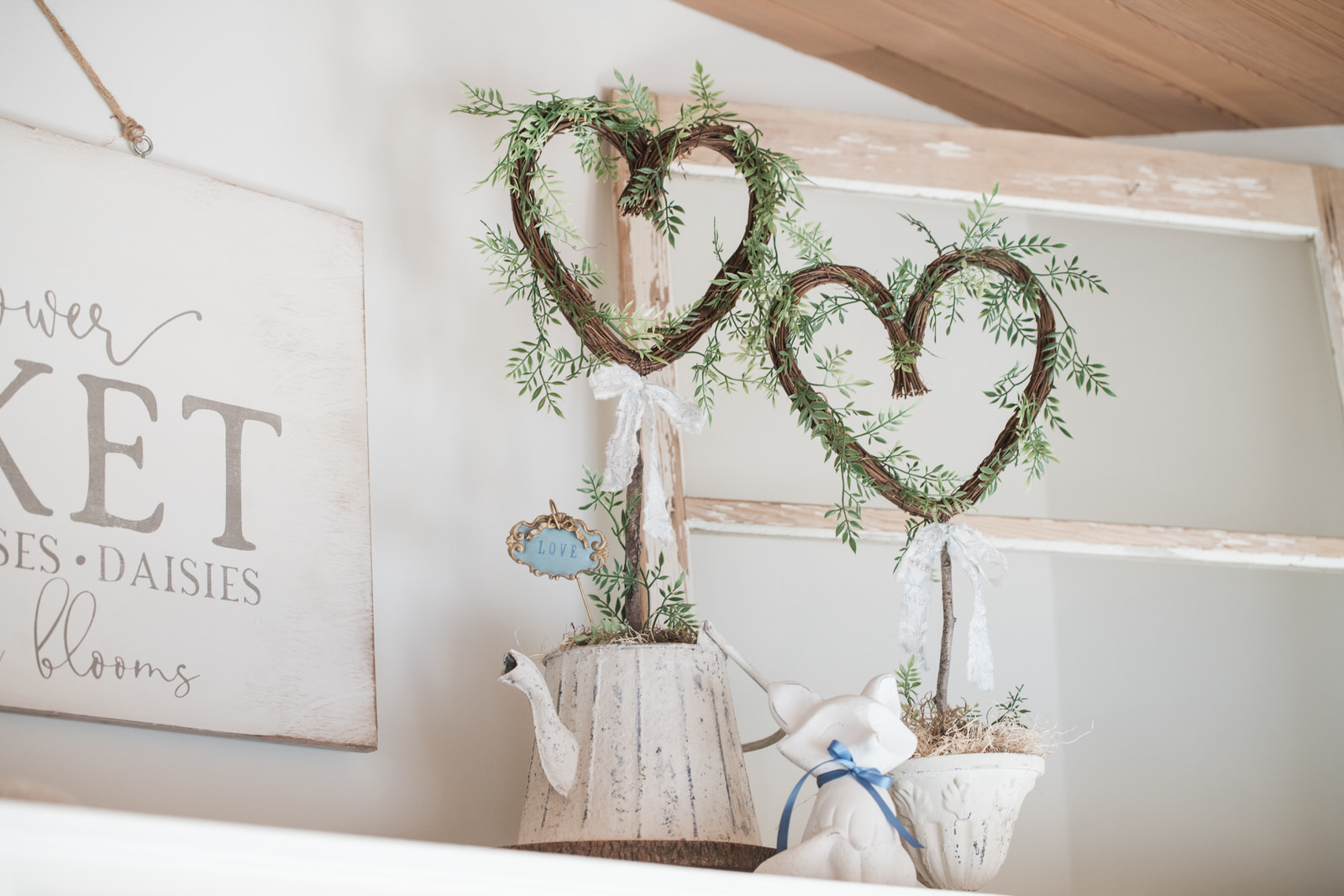 Cottage garden decor vignette with watering can and greenery