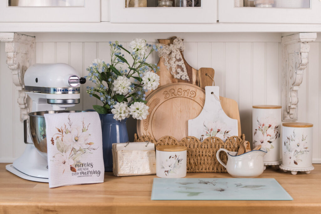Farmhouse kitchen open shelving styled for summer with blue florals and white canisters