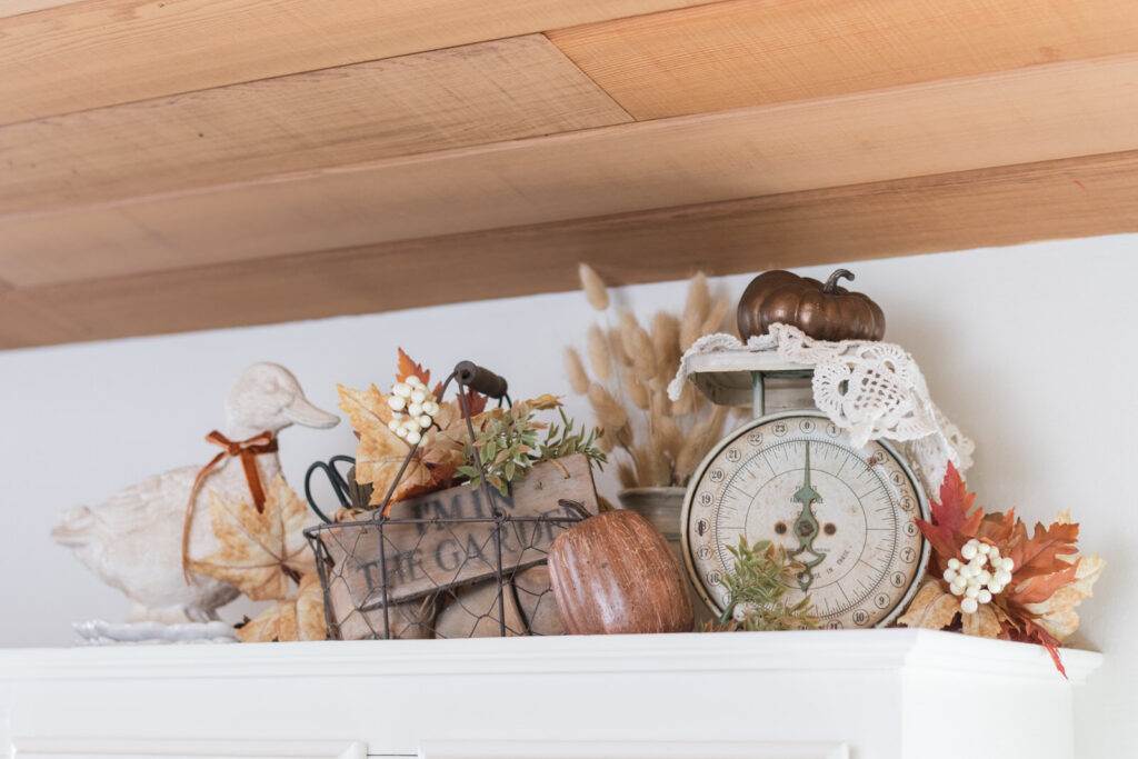 Vintage kitchen scale styled with autumn branches and botanical prints