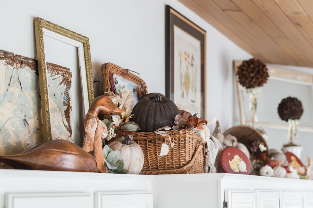 Vintage autumn decor styled above kitchen cupboards