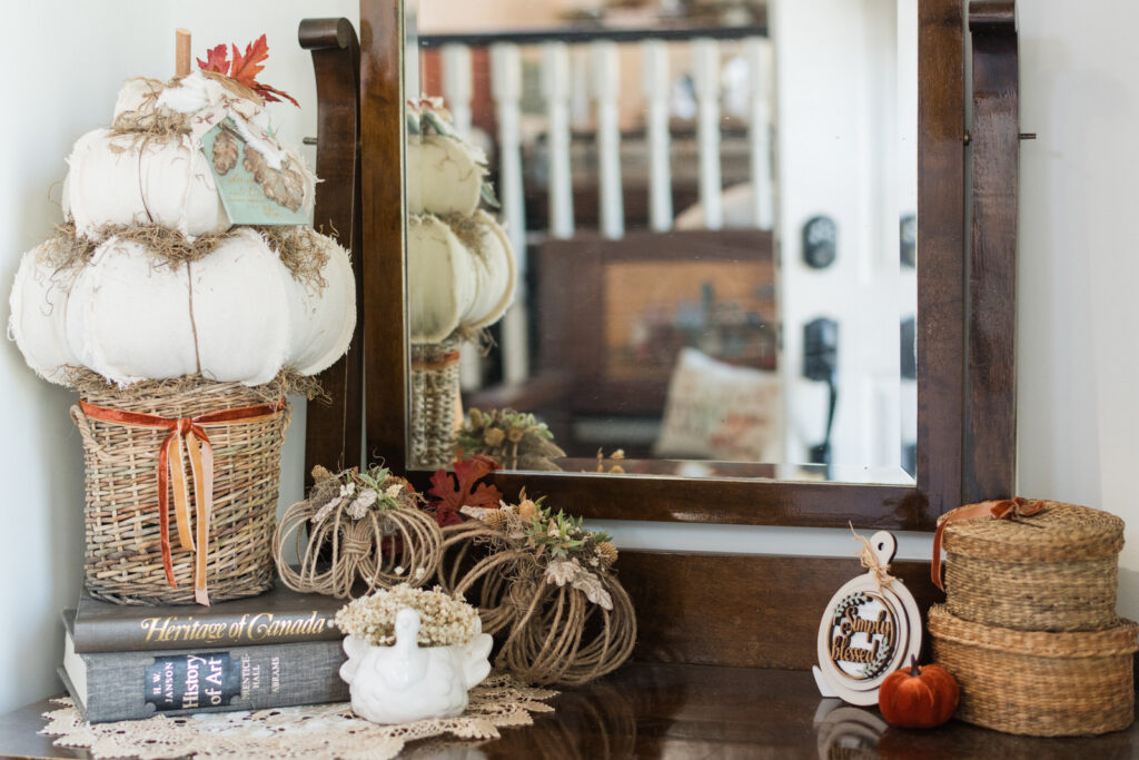 Autumn entryway decor with handmade pumpkins, a display above the closet, and a bench at the front entrance