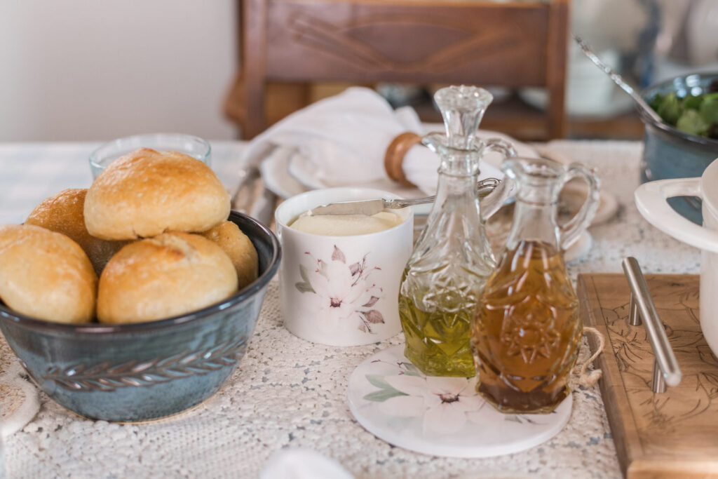 Magnolia canisters and trivets styled for summer on a dining table