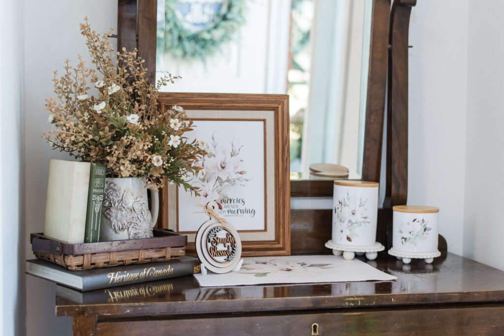 Magnolia canisters styled for fall in a cottage entryway catch-all
