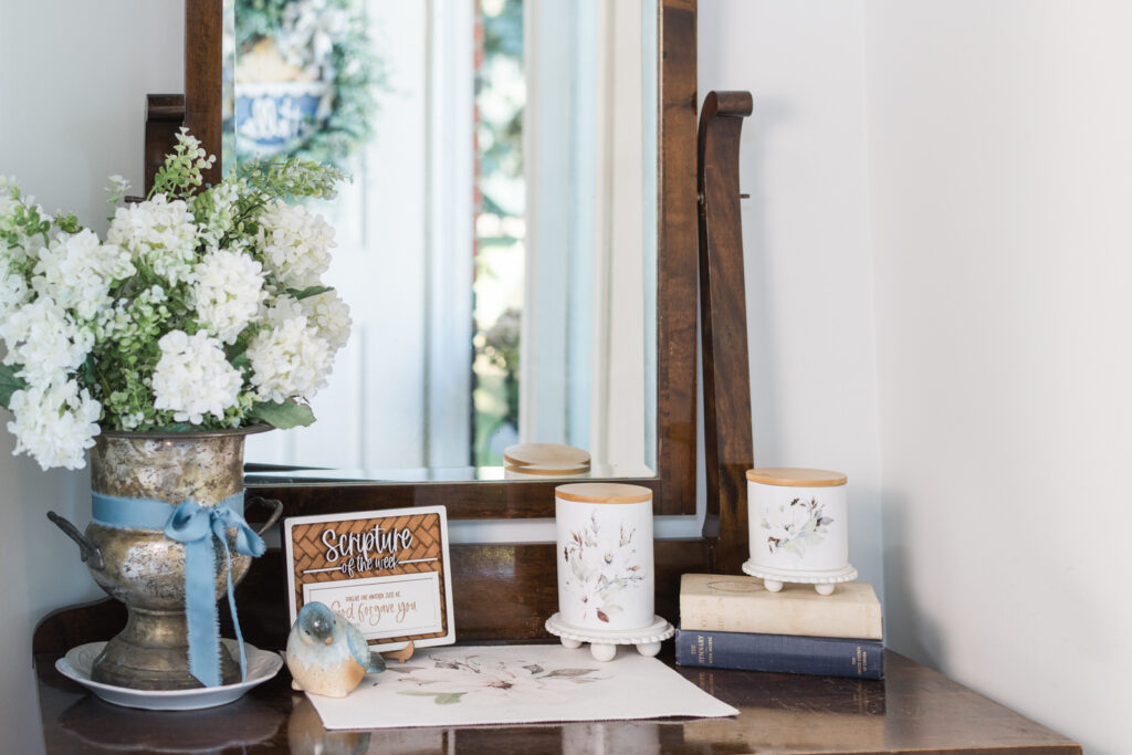 Magnolia canisters styled for summer in a cottage entryway catch-all