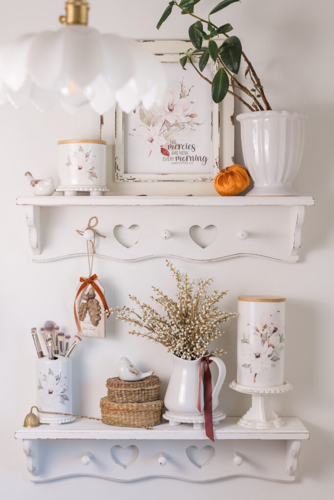 Magnolia canisters styled for fall in a guest bathroom