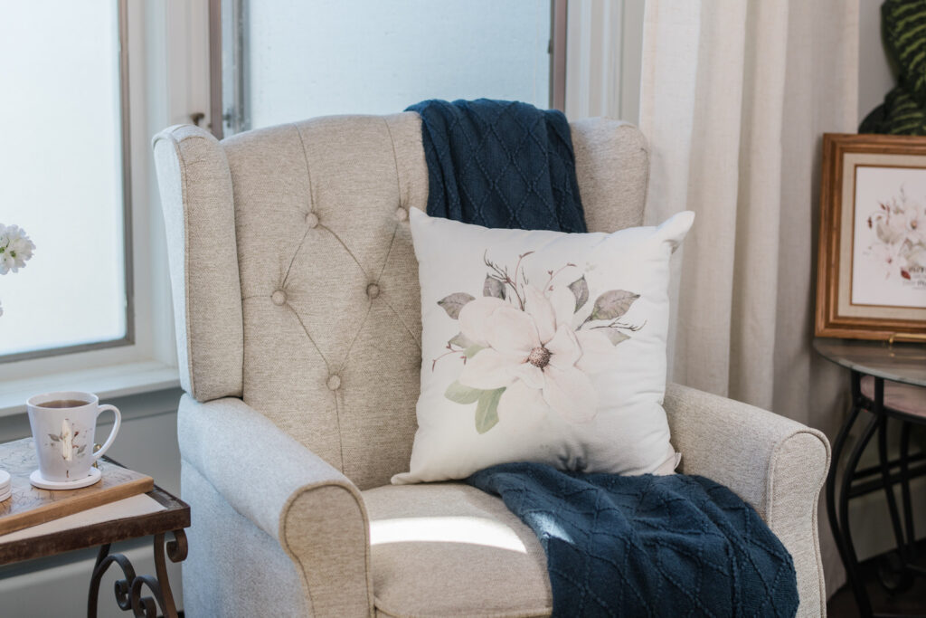 Magnolia pillows styled for summer in a cottage living room