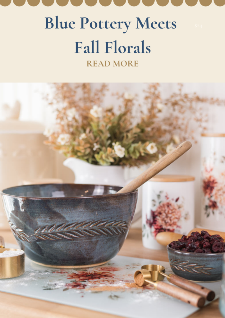 Autumn baking nook with blue pottery and floral canisters with a pitcher and floral stems in the background